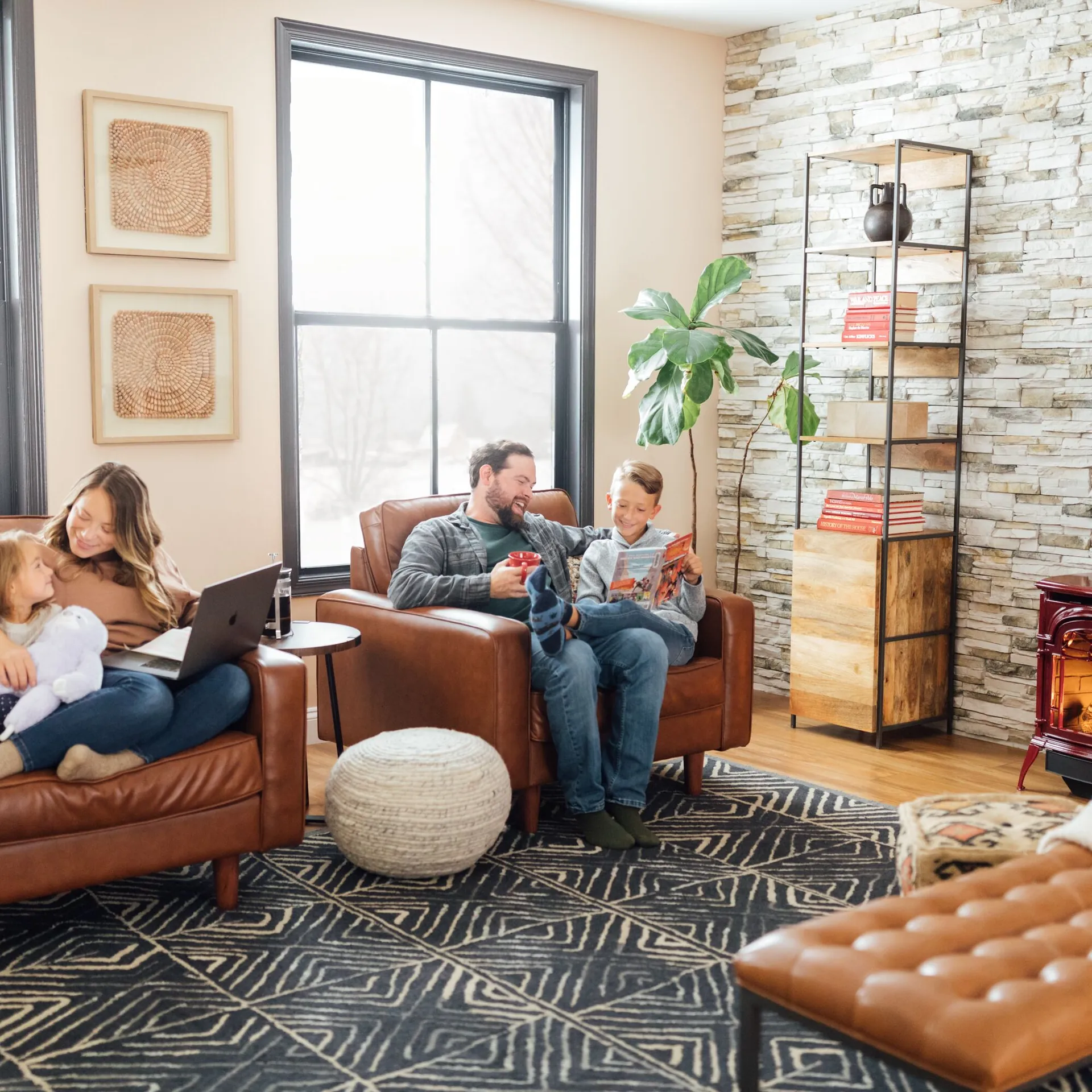 Family relaxing in a Wisconsin living room with the fireplace lit