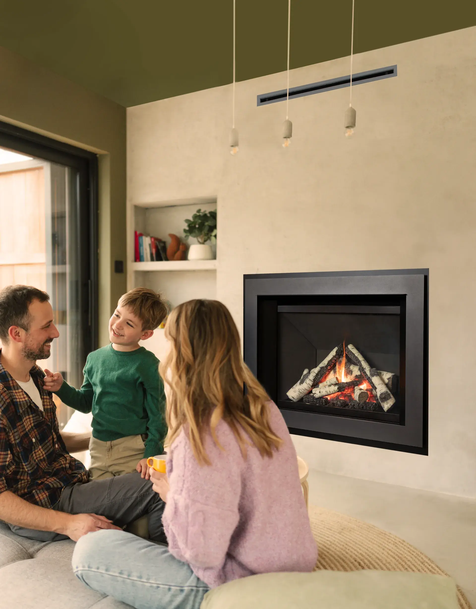Family enjoying a gas fireplace in a modern Wisconsin living room