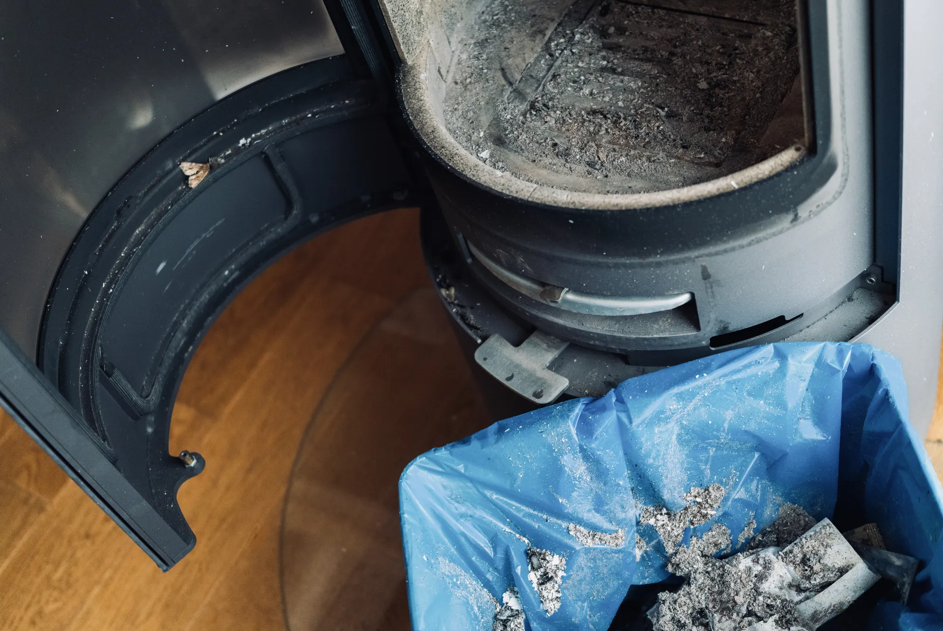 Wood stove with ash buildup needing service and cleanout
