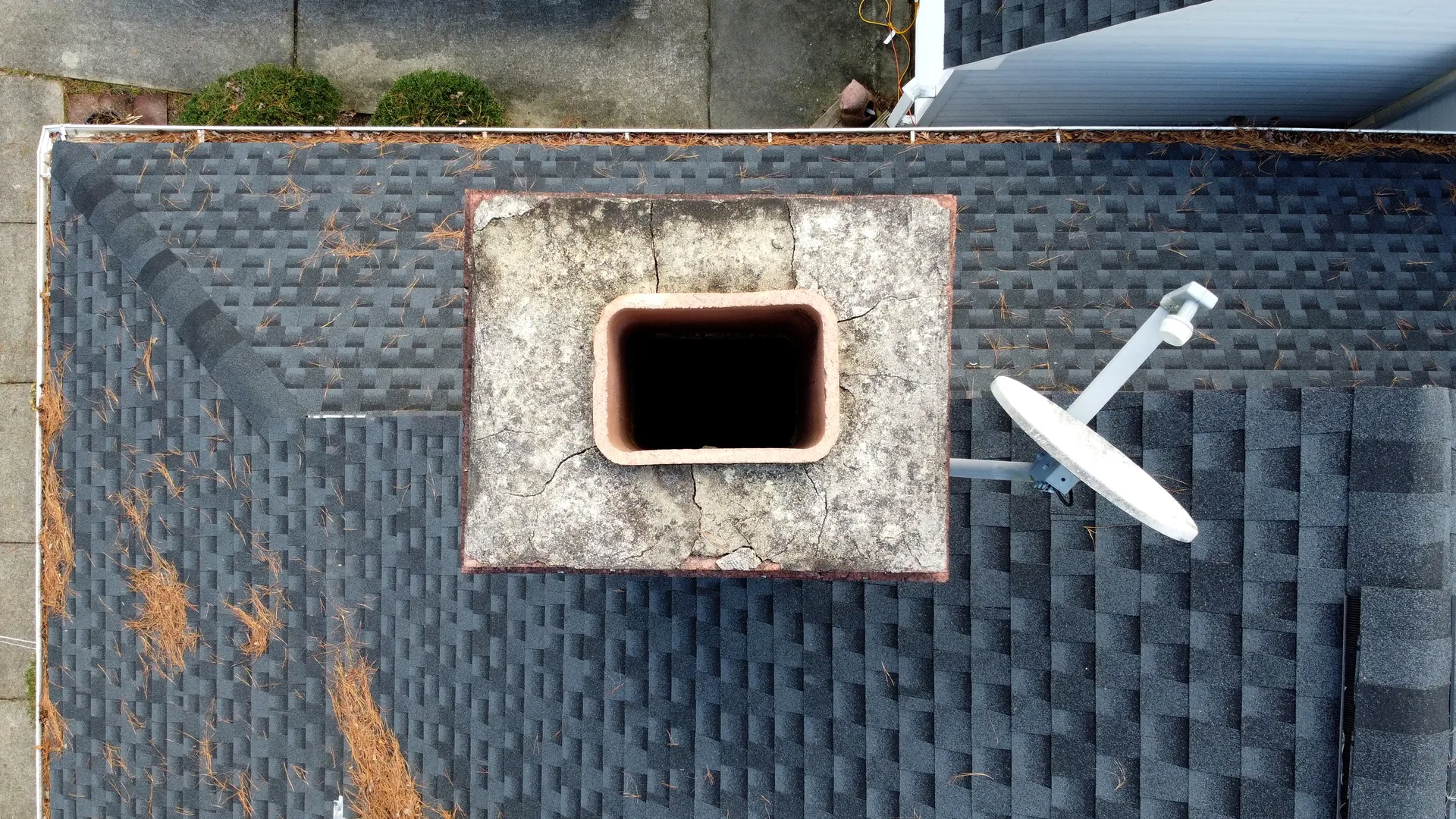 Aerial view of a cracked masonry chimney needing inspection